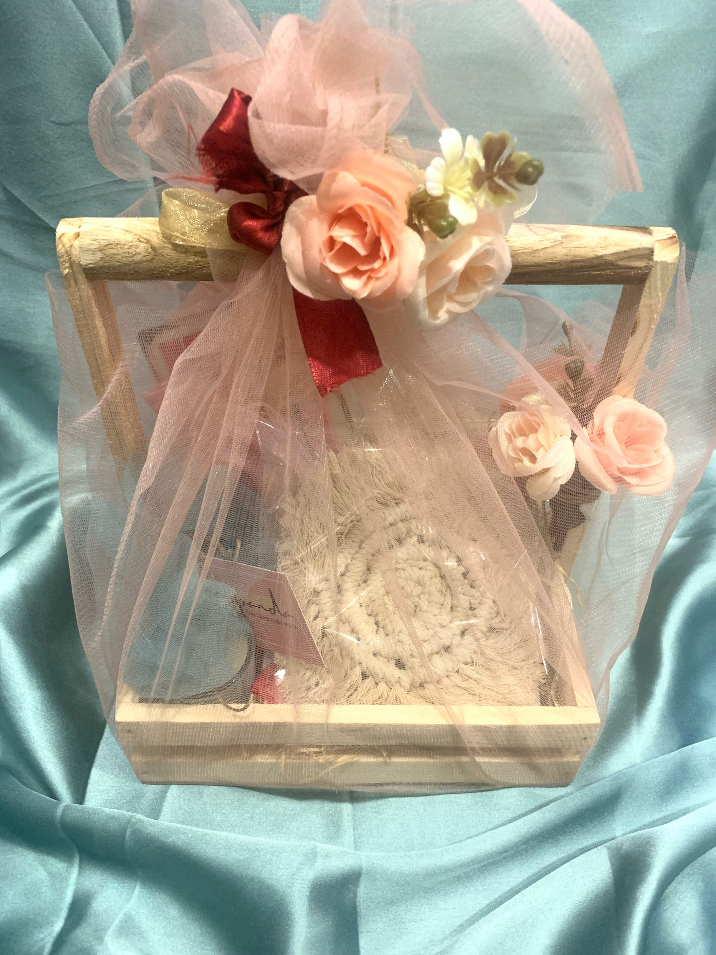 Wooden basket hamper wrapped in blush pink tulle with roses