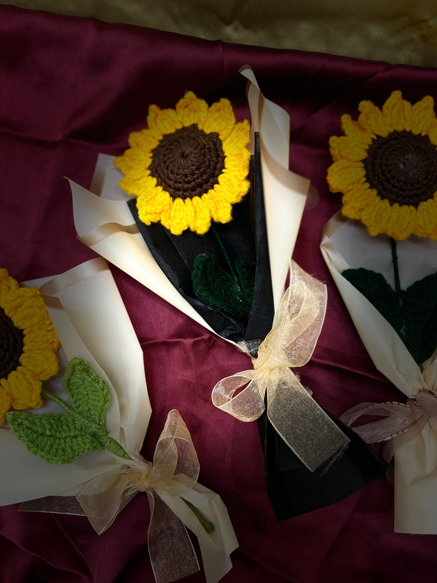 Handmade crochet sunflower bouquets wrapped in tissue and tied with ribbon