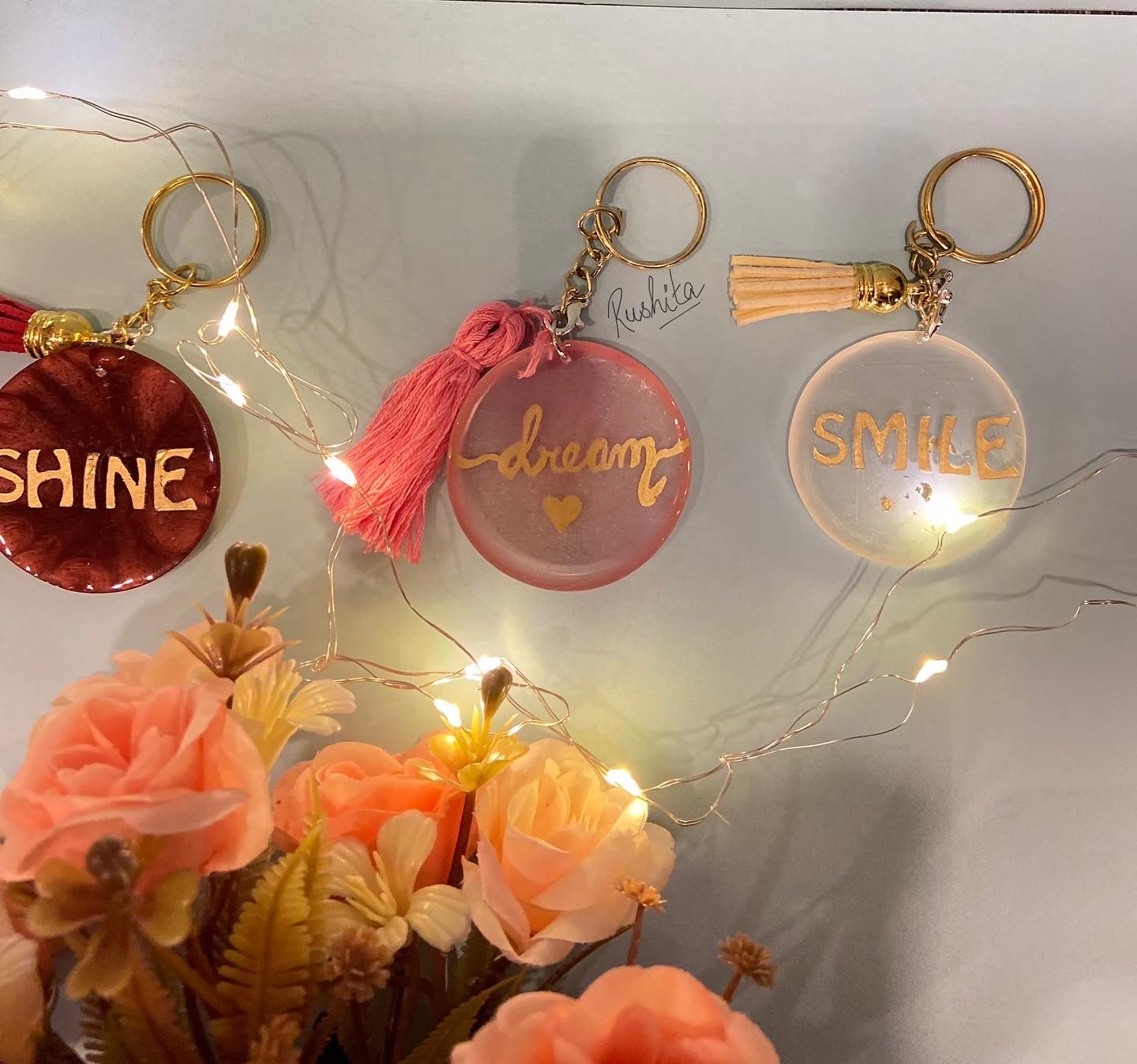 Shine, Dream and Smile round resin keychains with tassels