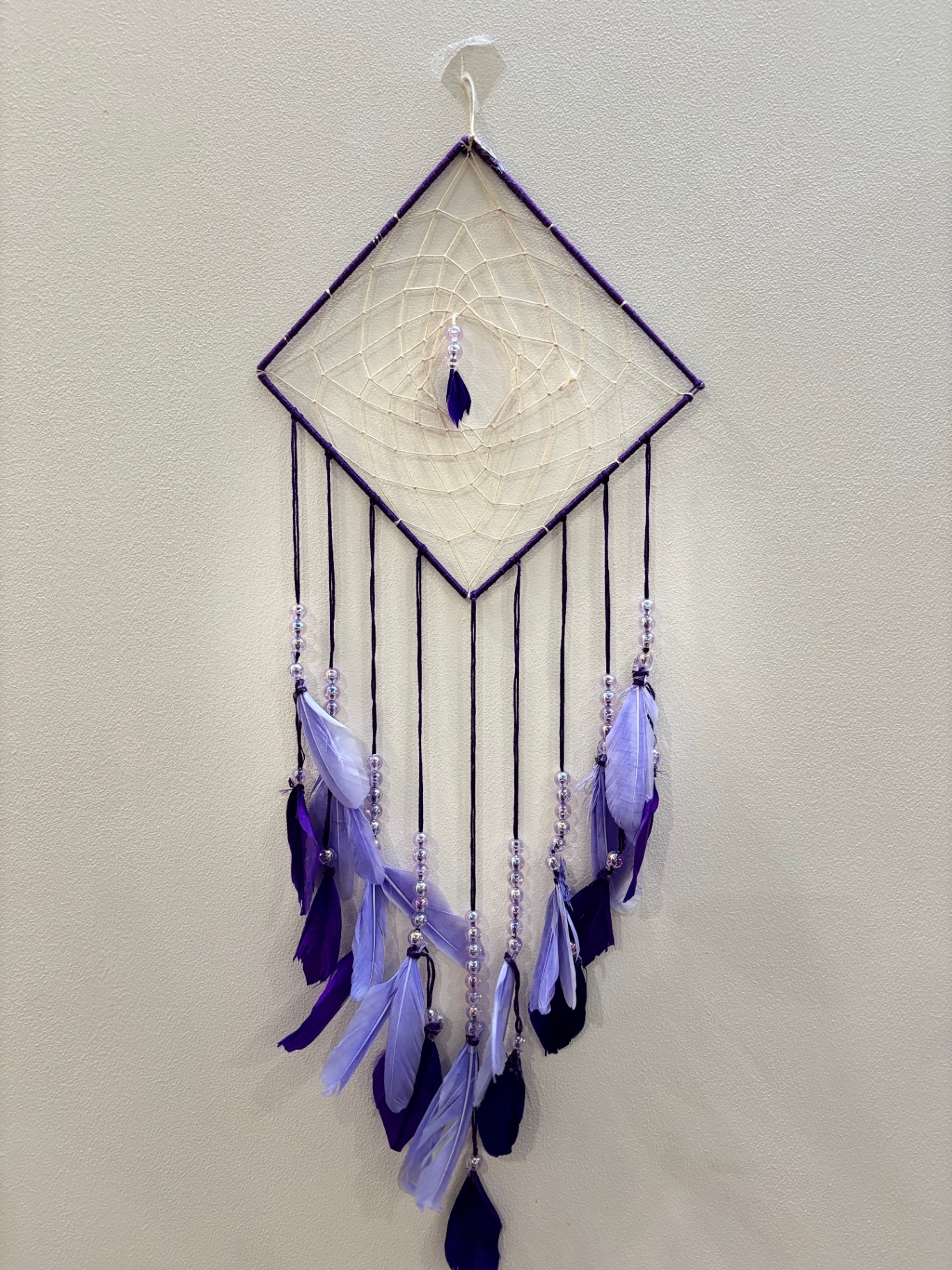 Large purple diamond dream catcher with feathers and beads
