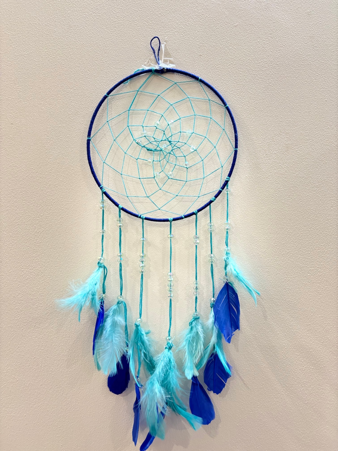 Large blue dream catcher with turquoise web and blue feathers