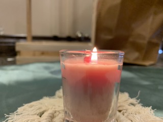 Lit pink rose votive candle